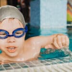 a-five-year-old-boy-in-swimming-glasses-in-the-poo-2022-11-14-05-50-54-utc