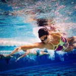 professional swimmer in the pool for the -what muscles does swimming work-article